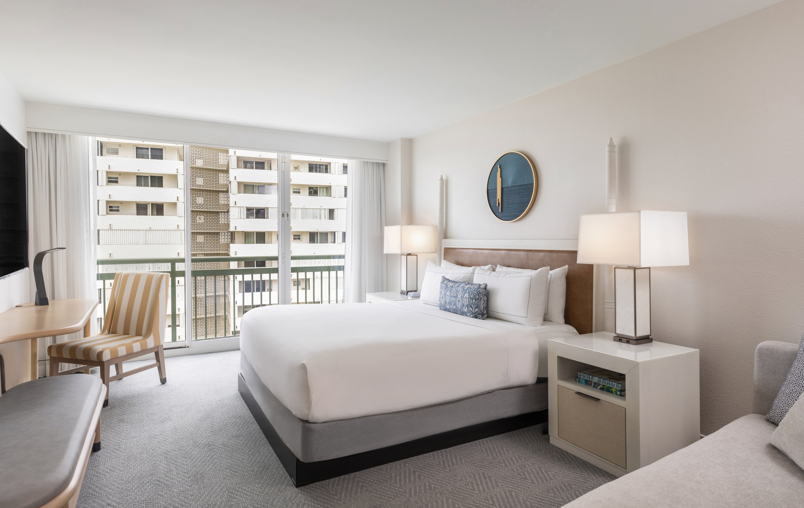 Spacious guest room with panoramic views and elegant decor at West Palm Beach Hotel.
