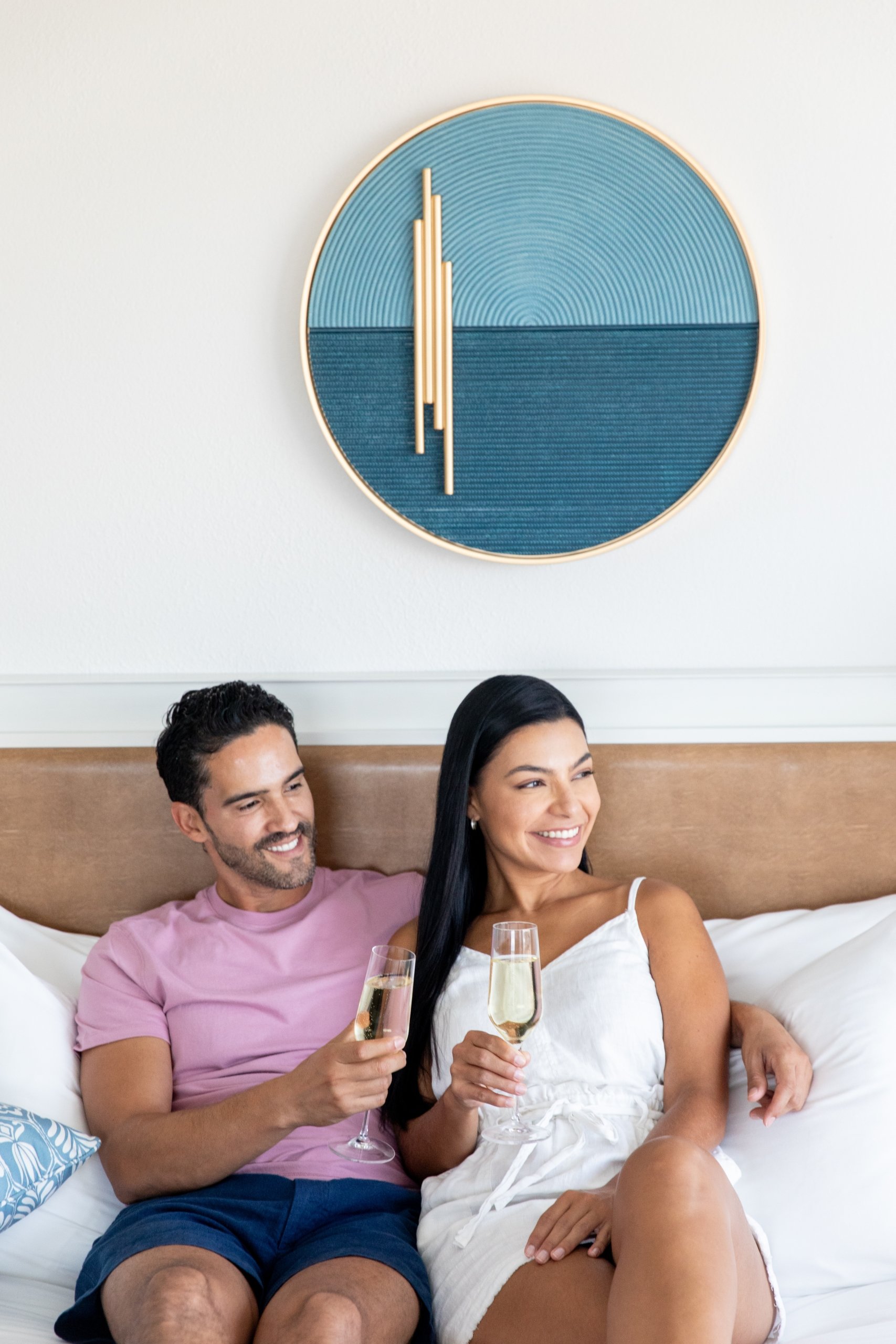 couple enjoying champagne in hotel guestroon